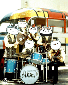 a group of cats are playing instruments in front of a bus called the chum family