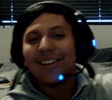 a man wearing a headset with a blue light on his neck