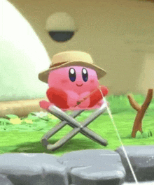 kirby is sitting on a folding chair holding a fishing rod and wearing a hat .