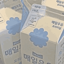 a bunch of boxes of milk with blue flowers on them .