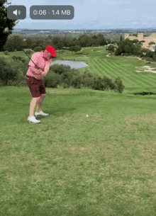 a man in a red hat is swinging a golf club on a golf course with a time of 1:06 and 1.4 mb