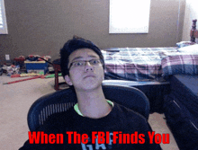 a man sitting in a chair with the words " when the fbi finds you " on the bottom