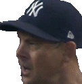 a man wearing a new york yankees baseball cap is looking at something .