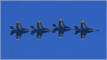 four blue jets with us navy written on the side of them