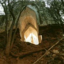 a tower is visible through a hole in a rock