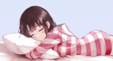 a girl in a pink and white striped shirt is sleeping on a bed with her eyes closed