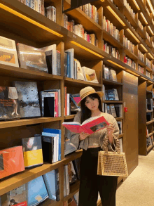 a woman in a hat is reading a book in a library with a book titled making it in a foreign language