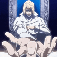 a man in a white coat is sitting in a chair with his hand outstretched