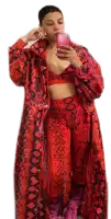 a woman taking a picture of herself in a red snakeskin outfit