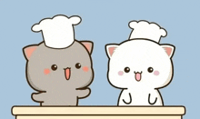 two cartoon cats wearing chef hats are sitting at a table .