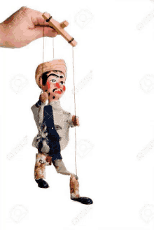 a hand is holding a wooden puppet on a string .