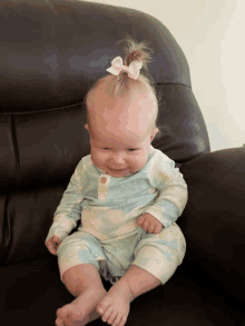 a baby in a tie dye outfit is sitting on a chair