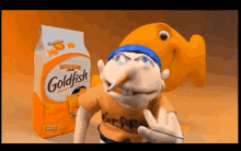 a cartoon character is smoking a cigarette in front of a bag of goldfish crackers