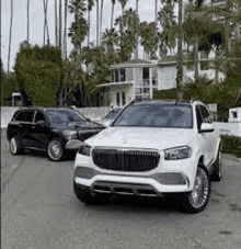 a black and white photo of two cars parked next to each other on a street .