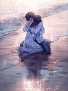 a man and a woman are hugging each other on a beach .