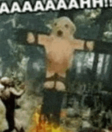 a stuffed animal is hanging from a cross with a screaming face on it .