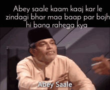 a man sitting in a chair with a caption that says abey saale on it