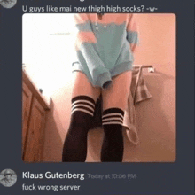 a person is wearing thigh high socks and a blue hoodie .