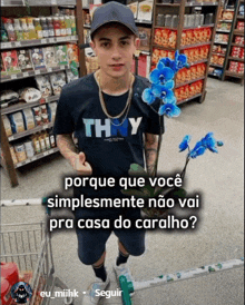 a young man wearing a thy shirt is standing in a store