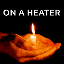 a hand holding a lit candle with the words on a heater written above it