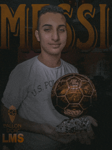 a young man holds a soccer ball in front of a poster that says messi