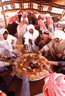 a group of men are sitting around a plate of food with the words eastep on the bottom