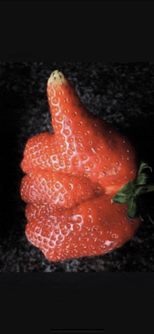 a strawberry that is giving a thumbs up