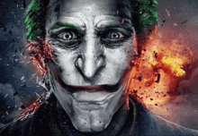 a close up of the face of the joker with a fire background