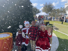 a group of children posing for a picture with santa clause