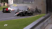 a race car is crashing on a race track .