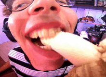 a close up of a person 's mouth with a bottle of ketchup on the shelf in the background