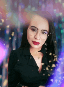 a woman wearing glasses and a black shirt is standing in front of a colorful background