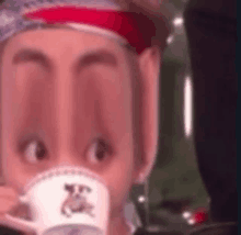 a close up of a person drinking from a cup with a very long nose .