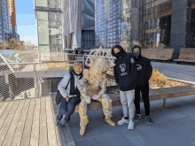 a man wearing a hoodie that says nets brooklyn stands next to two other people