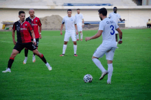 a soccer player wearing a number 3 jersey kicks the ball