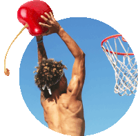 a man is holding a red cherry over a basketball net