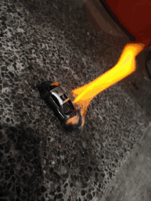 a toy car with the letter h on the side is on fire