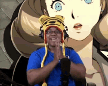 a man wearing a tiger hat and headphones is standing in front of a microphone in front of a cartoon girl .