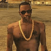 a shirtless man wearing sunglasses and a gold chain is standing on a street .