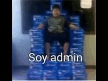 a boy is sitting on top of a stack of pepsi boxes .