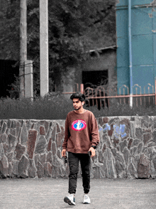 a young man wearing a brown sweatshirt that says " happy world " on it