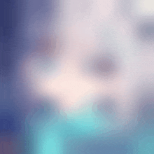 a blurred image of a person 's face with a blue background