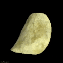 a close up of a potato chip on a black background on a black background .