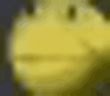 a blurry picture of a yellow ball with a face on it