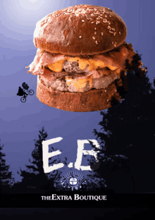 a poster for the extra boutique shows a hamburger with bacon and cheese