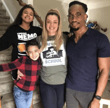 a family posing for a picture with a girl wearing a shirt that says finding nemo