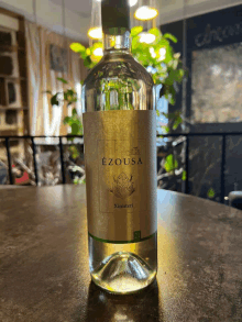 a bottle of ezousa wine on a table