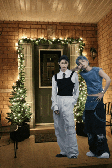 a couple of people standing in front of a door with christmas lights