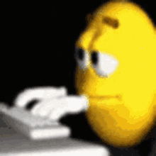 a yellow smiley face is using a computer keyboard .