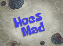 the word hoes mad is written in blue on a concrete surface